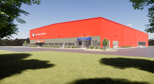 A large red commercial building with a sign reading “First Mobile FCU” above the entrance, featuring expertly crafted MEP/FP designs by Engineered Systems Inc., surrounded by a parking lot and greenery under a clear sky.